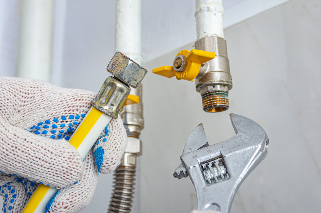 A technician is replacing or connecting a residential gas line