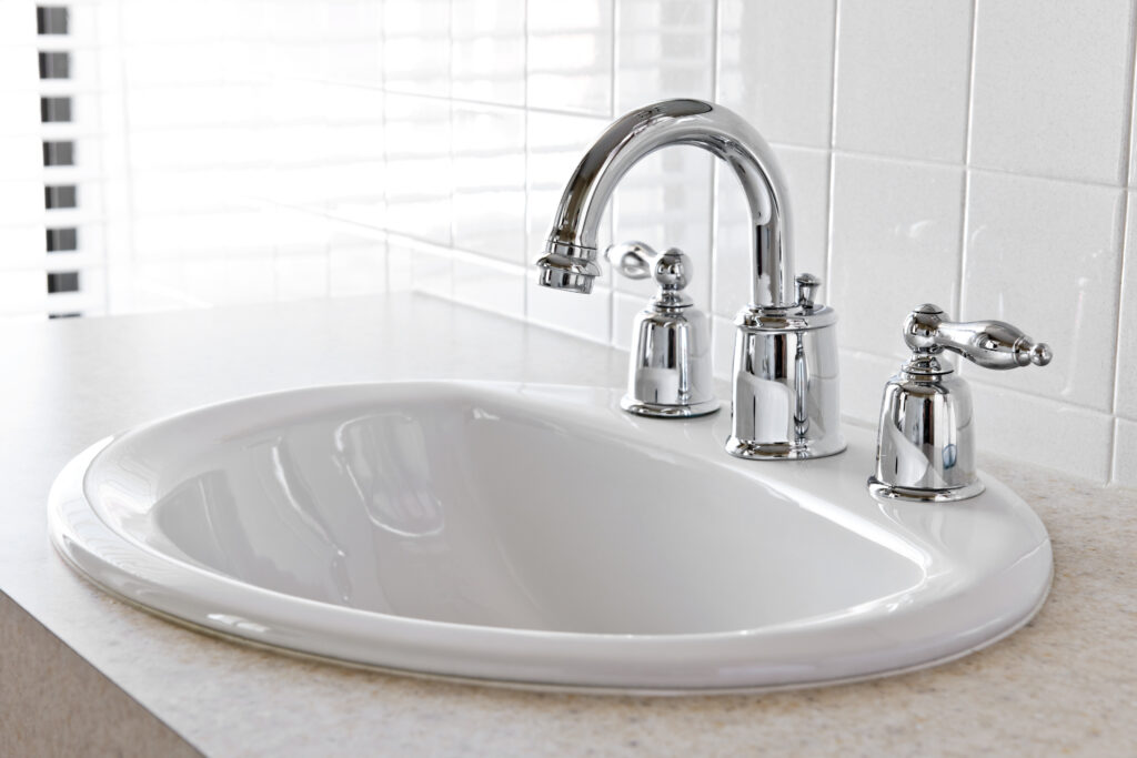 Bathroom with white sink and faucet