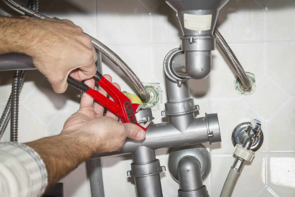 Plumber repiping a home's kitchen plumbing system