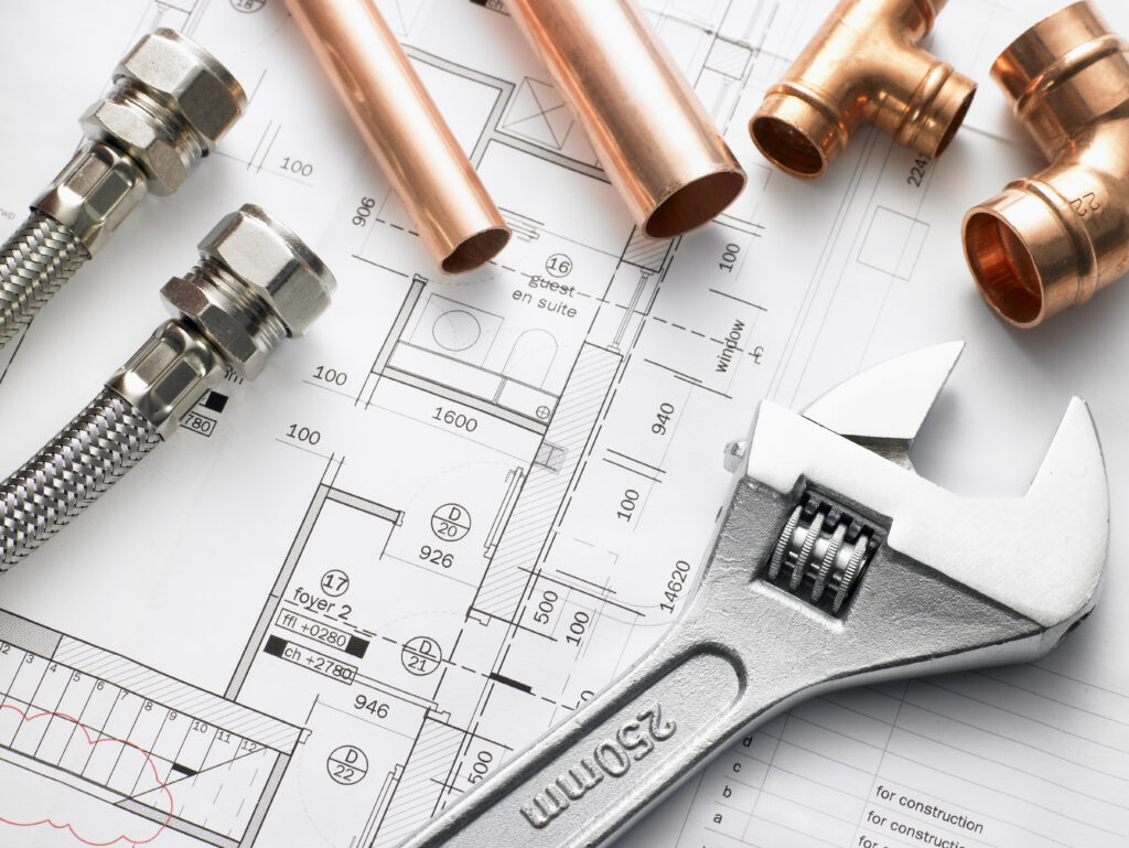 Closeup shot of plumbing equipment on house plans